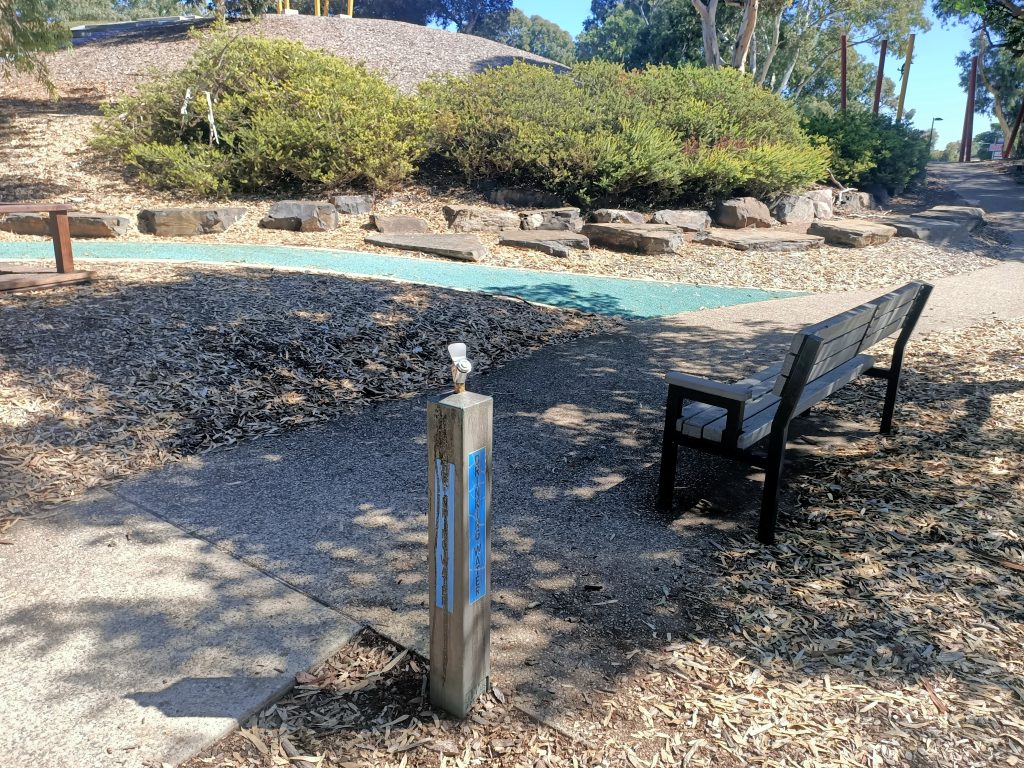 Water fountain and park bench