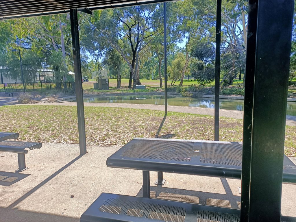 picnic bench with regency park golf course in background