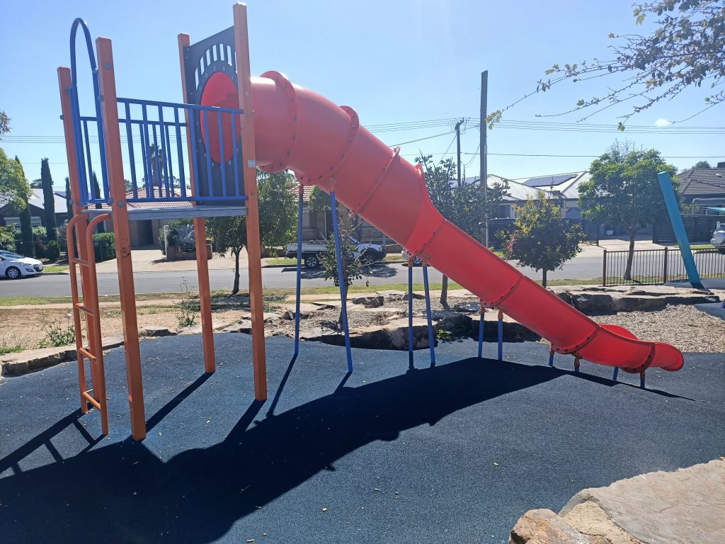 Red slide with climbing ladder