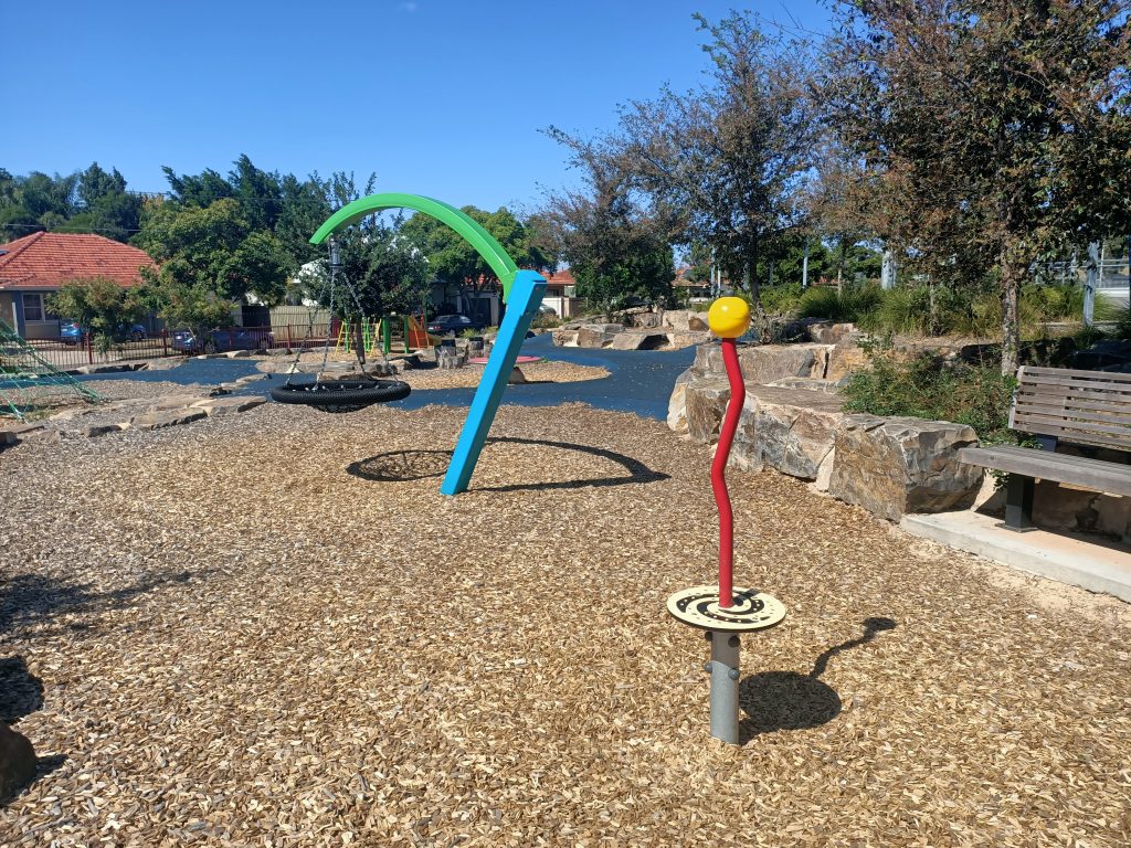 Red spinner pole, nest swing in background