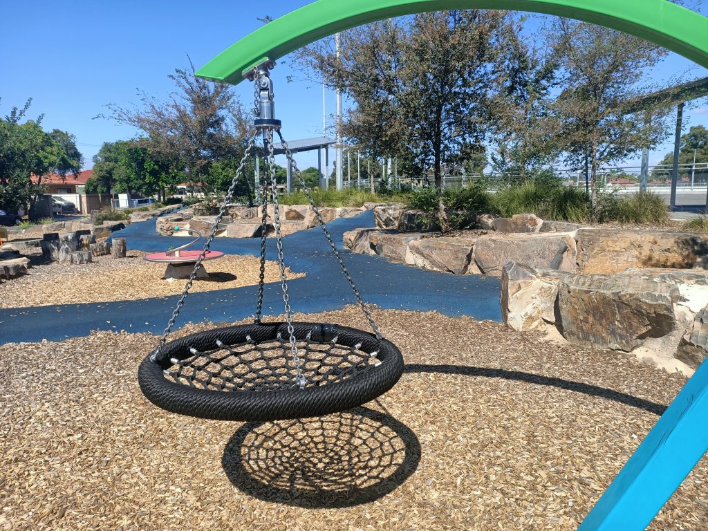 Nest swing hanging from green pole