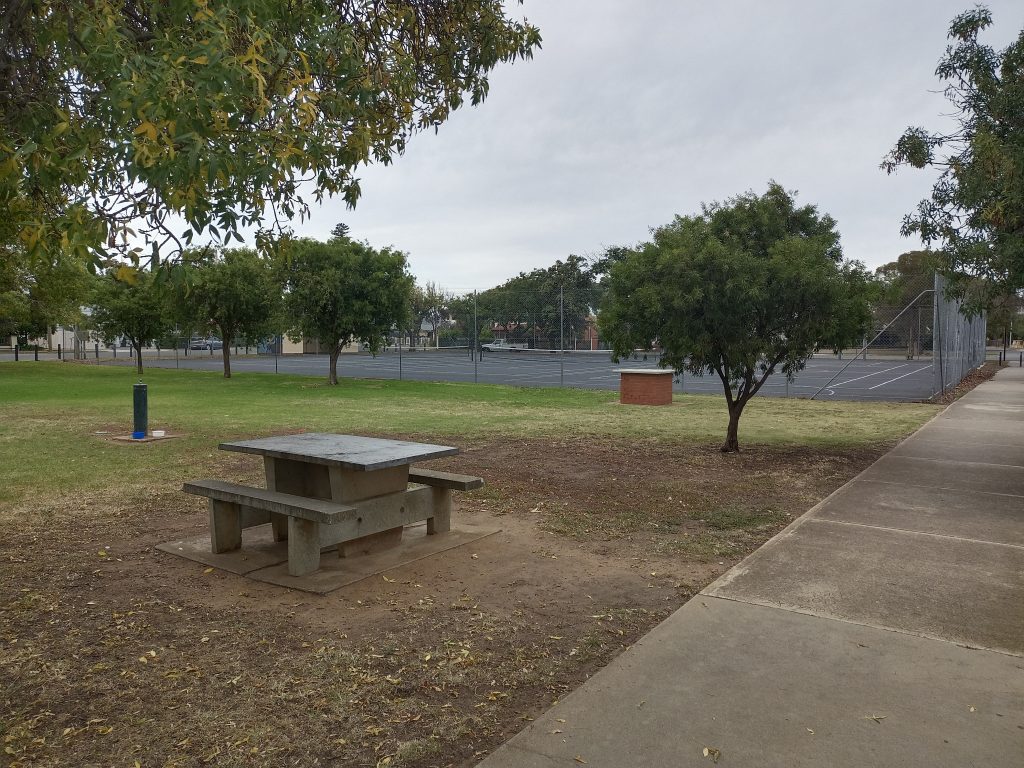 Picnic bench overlooking tennis courts