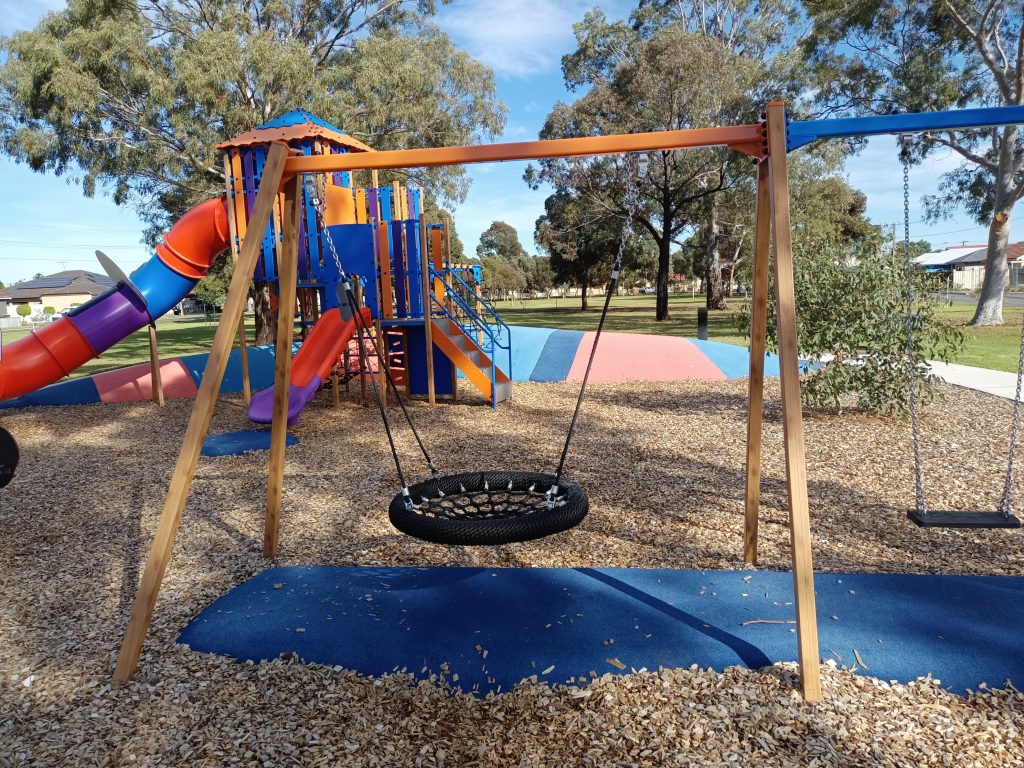 Nest swing with playground behind