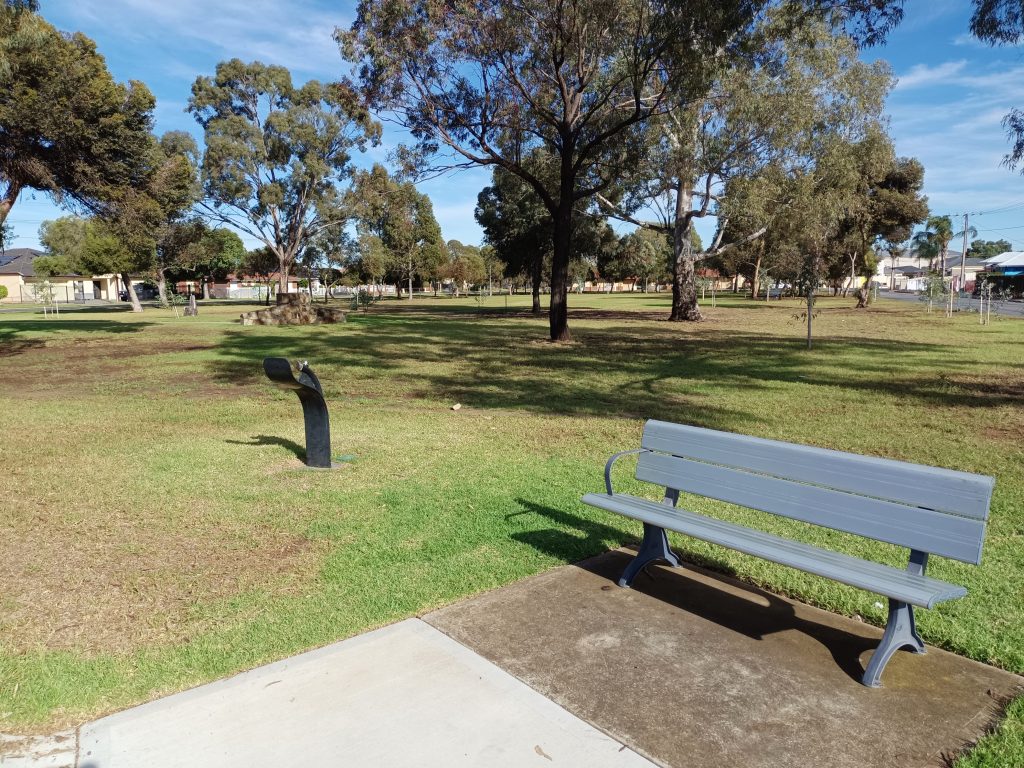 Park bench and water fountain