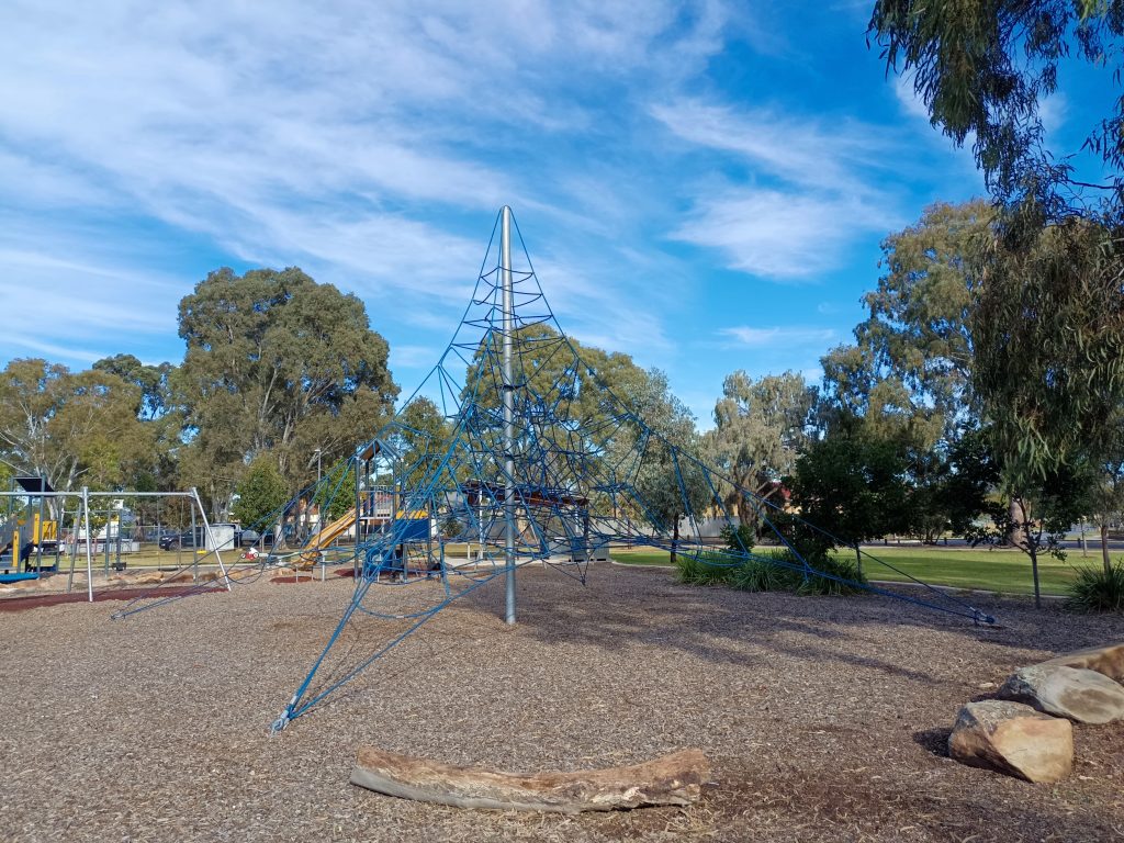 Blue rope climbing pyramid on bark chips